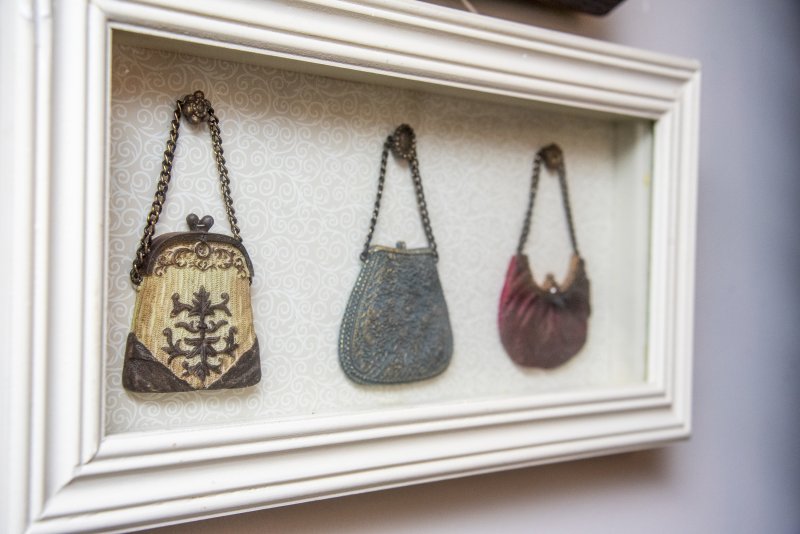 Tiny vintage change purses are framed in Marla and Tom Norton’s home.